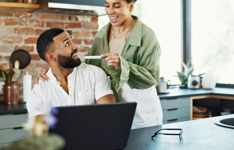 Couple, happy and surprise with pregnancy test in home with announcement, celebration and ivf succe